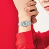 A close-up shot of a woman's wrist wearing a silver Casio watch, with her other hand resting on top. Produktbild-Vorschau
