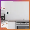 A modern kitchen counter with a coffee maker, a smoke detector, and an oven. Podgląd zdjęcia produktu