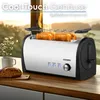 A toaster with bread inside, placed on a wooden countertop next to a cup and a loaf of bread, with a blurred outdoor background. Produktbild-Vorschau