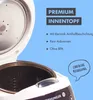 Close-up view of an open rice cooker with promotional text and graphics overlay. Produktbild-Vorschau