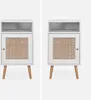 Two identical white nightstands with rattan drawer fronts are displayed side-by-side against a light gray background. Produktbild-Vorschau