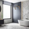A modern bathroom with a bathtub, window, and a wall-mounted drying rack. Produktbild-Vorschau