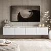 A modern living room with a wall-mounted TV cabinet and a large television. Náhľad obrázku produktu