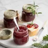 Jars of jam on a marble board with bread and cheese. Produktbild-Vorschau