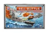 The image shows the box art for a board game called 'Sea Battle'. It depicts a naval battle scene with warships, explosions, and aircraft. Anteprima dell’immagine prodotto