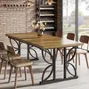 A dining room scene with a wooden table and chairs, a wine rack in the background, and a large window overlooking a garden. Produktbild-Vorschau