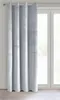 A light gray curtain with grommets hangs in front of a window. Náhľad obrázku produktu