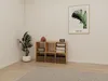 A corner of a room with a wooden cube shelf unit, a plant, and a framed picture on the wall. Produktbild-Vorschau