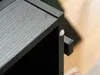 Close-up of a black table corner with a white protective pad. Náhľad obrázku produktu