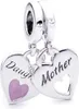 A silver charm with two heart-shaped pendants, one pink and one with a cut-out heart. Náhled obrázku produktu