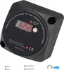A black voltage-sensitive relay with a digital display and indicator lights, shown from a slightly elevated front-diagonal angle. It is placed on a light gray background with some screws and a wire connector visible at the bottom. Produktbild-Vorschau