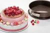 A decorated cake and a springform pan are displayed on a white surface. Produktbild-Vorschau