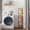 A laundry room with a washing machine and a bamboo shelf. Produktbild-Vorschau