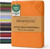 A stack of folded bed sheets in various colors is shown next to a folded orange bed sheet with a product label. Produktbild-Vorschau