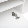 Close-up of a white cabinet hinge. Anteprima dell’immagine prodotto