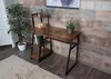 A desk with shelves in a room with wooden walls and a rug. Náhľad obrázku produktu