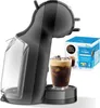 A black Nescafé Dolce Gusto coffee machine with a glass of iced coffee and a box of iced frappe pods. Produktbild-Vorschau