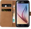 A brown flip case for a Samsung Galaxy S6 phone, with cards and banknotes inserted. Produktbild-Vorschau