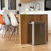 A modern kitchen or dining area with a breakfast bar, chairs, and a stainless steel trash can. Produktbild-Vorschau