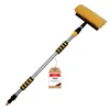 A telescopic car wash brush with a yellow brush head and silver pole, shown against a white background. A small brown tag with red and black text is attached to the pole. Náhľad obrázku produktu