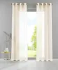 A window with cream-colored curtains and a small side table with a vase and books. Produktbild-Vorschau