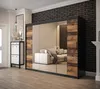 A modern bedroom or hallway with a large mirrored wardrobe, a shoe cabinet, and a sofa visible in the reflection. Produktbild-Vorschau