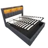 A bed frame with its mattress support system lifted to reveal storage space underneath. Produktbild-Vorschau