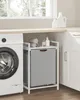 A laundry room scene with a washing machine, a laundry basket with a shelf, and cleaning supplies on a countertop. Produktbild-Vorschau
