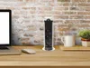 A pop-up power strip is shown on a wooden desk next to a laptop and a mouse, with a brick wall in the background. Náhľad obrázku produktu