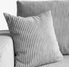 A close-up view of a gray corduroy sofa with pillows. Produktbild-Vorschau