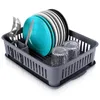 A dish drying rack filled with plates, glasses, and cutlery. Produktbild-Vorschau