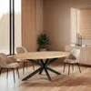 A dining room scene with an oval wooden table and chairs. Voir les images du produit