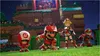 Mario characters in soccer uniforms on a grassy field with stadium seating in the background. Produktbild-Vorschau