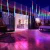 An outdoor patio at night, decorated with colorful LED string lights that resemble falling icicles. Náhled obrázku produktu