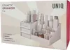 The image shows the packaging of a white cosmetic organizer with drawers and compartments, filled with various cosmetic bottles and containers. Náhľad obrázku produktu