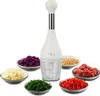 A white manual food chopper is shown in the center, surrounded by small bowls of chopped vegetables and meat. Náhľad obrázku produktu