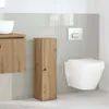 A modern bathroom with a wall-mounted toilet, a wooden cabinet, and a sink. Podgląd zdjęcia produktu