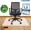 A black office chair is placed on a semi-transparent floor mat on a wooden floor. There are several promotional logos and text overlays around the chair. Produktbild-Vorschau