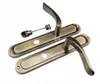 Two door handles with backplates and a connecting rod, displayed on a white background. Produktbild-Vorschau