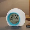 A digital alarm clock with a light-up feature sits on a table. Produktbild-Vorschau