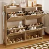 A wooden shoe cabinet with multiple shelves and doors, filled with shoes. Anteprima dell’immagine prodotto