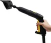 A hand holding a black and yellow steam cleaner with a cleaning attachment. Náhled obrázku produktu