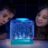 Two children are looking at a glowing aquarium with small creatures inside. Voir les images du produit