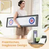 A woman holds a portable shuffleboard and curling game board. A smaller inset image shows the board stored vertically. Produktbild-Vorschau