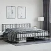 A bedroom scene with a metal bed frame and bedding. Podgląd zdjęcia produktu