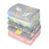 A stack of five folded blankets with different patterns. Náhled obrázku produktu
