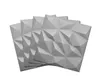 A stack of four grey 3D wall panels with geometric patterns. Produktbild-Vorschau