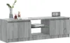 A gray TV stand with decorative figures and a digital clock on top. Náhľad obrázku produktu