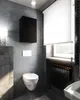 A modern bathroom with a wall-mounted cabinet, toilet, and radiator. Voir les images du produit