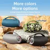 Four ZEALOT speakers in different colors (blue, camouflage, gray, black) are displayed on rocks with a sky and foliage background. Náhled obrázku produktu